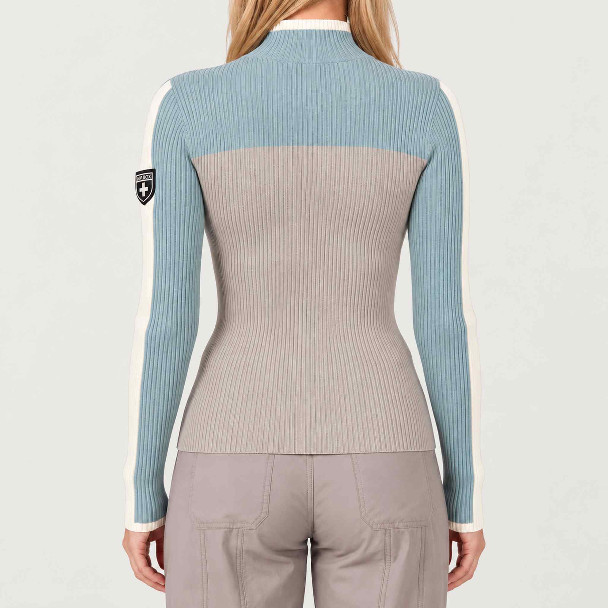 Model wearing Alp n Rock women's Ali Rib Sweater in Stone/Silver Blue, back view.