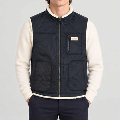 Amundsen Harvester Reverso Waxed Vest, front view on model, navy waxed side.