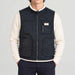 Amundsen Harvester Reverso Waxed Vest, front view on model, navy waxed side.