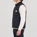 Amundsen Harvester Reverso Waxed Vest, side view on model, navy waxed side.