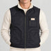 Amundsen Harvester Reverso Waxed Vest, close-up fabric detail on model, navy waxed side.