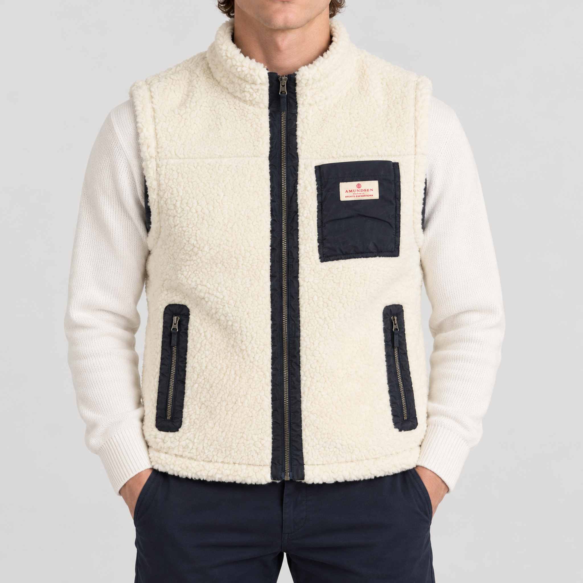 Amundsen Harvester Reverso Waxed Vest, front view on model, cream fleece side.