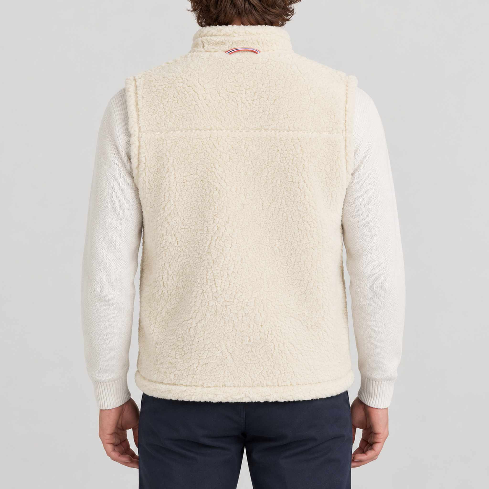 Amundsen Harvester Reverso Waxed Vest, back view on model, cream fleece side.