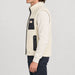 Amundsen Harvester Reverso Waxed Vest, side view on model, cream fleece side.
