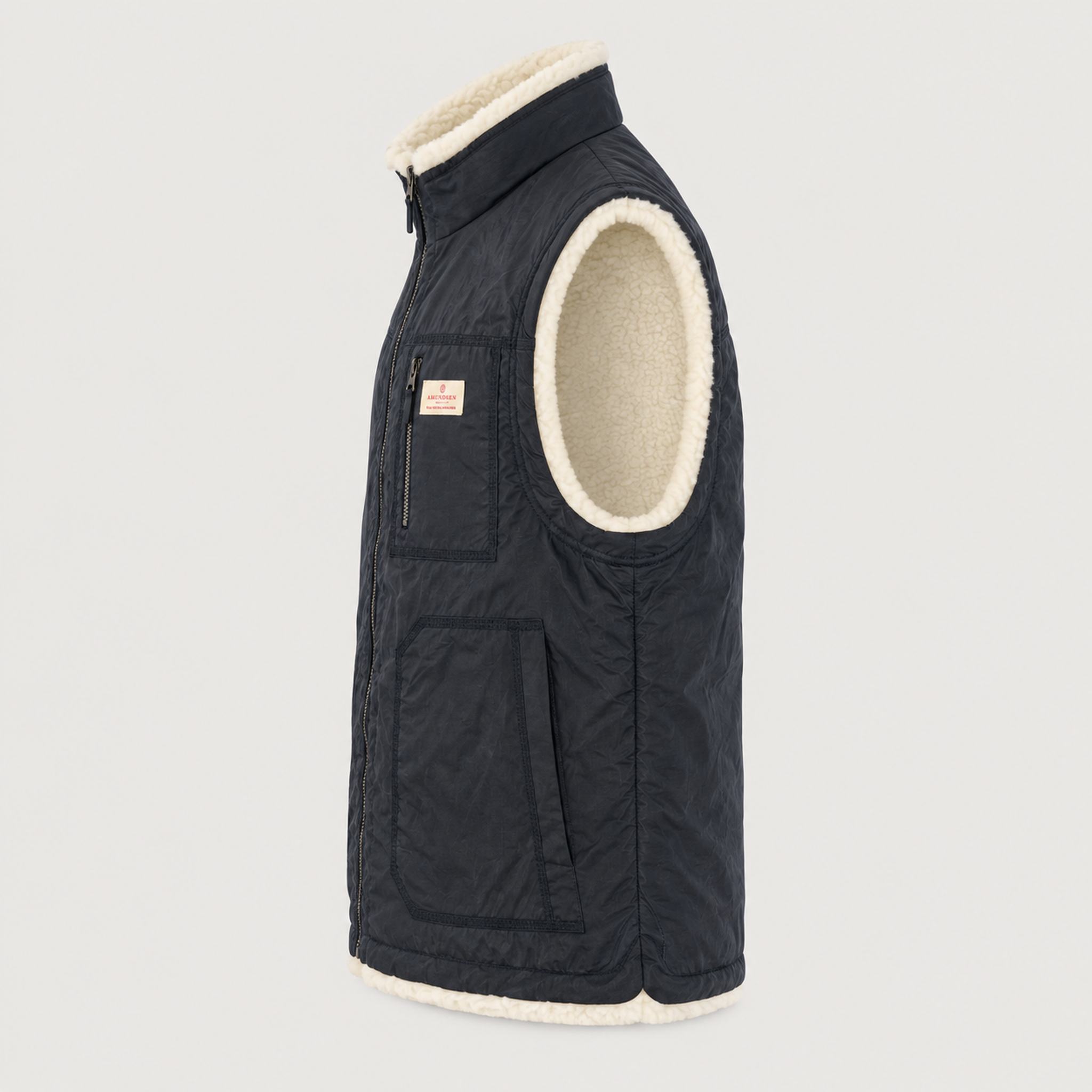 Amundsen Harvester Reverso Waxed Vest, side product view, navy waxed side.