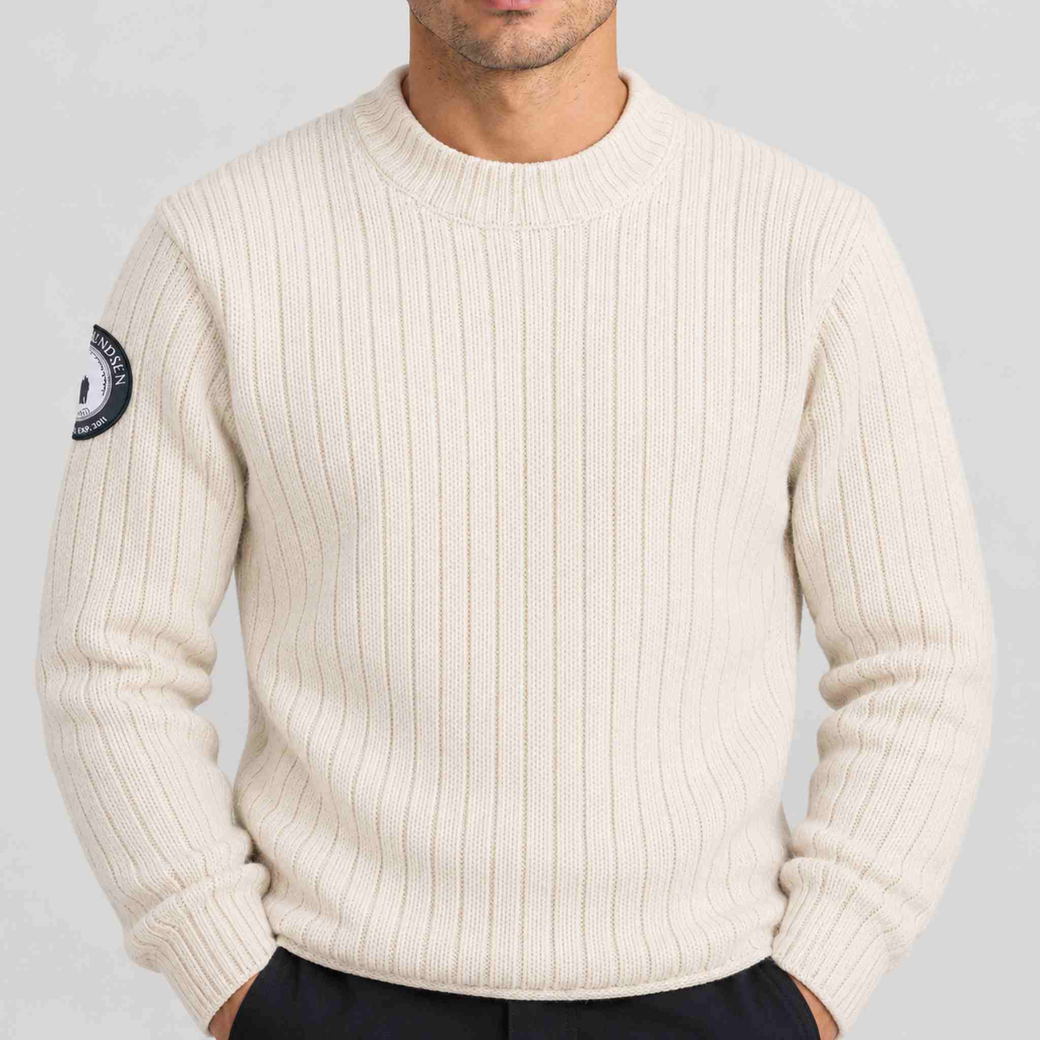 Amundsen Roald Roll Neck in Oatmeal, close-up fabric detail on model.