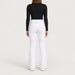 Fera women's Kelly Pant in White, back view on model.