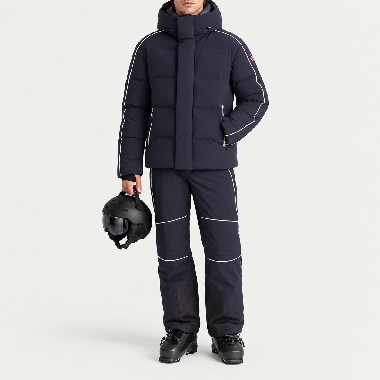 Fusalp men's Atila Graphic Ski Jacket in Navy, full outfit on model holding a ski helmet.
