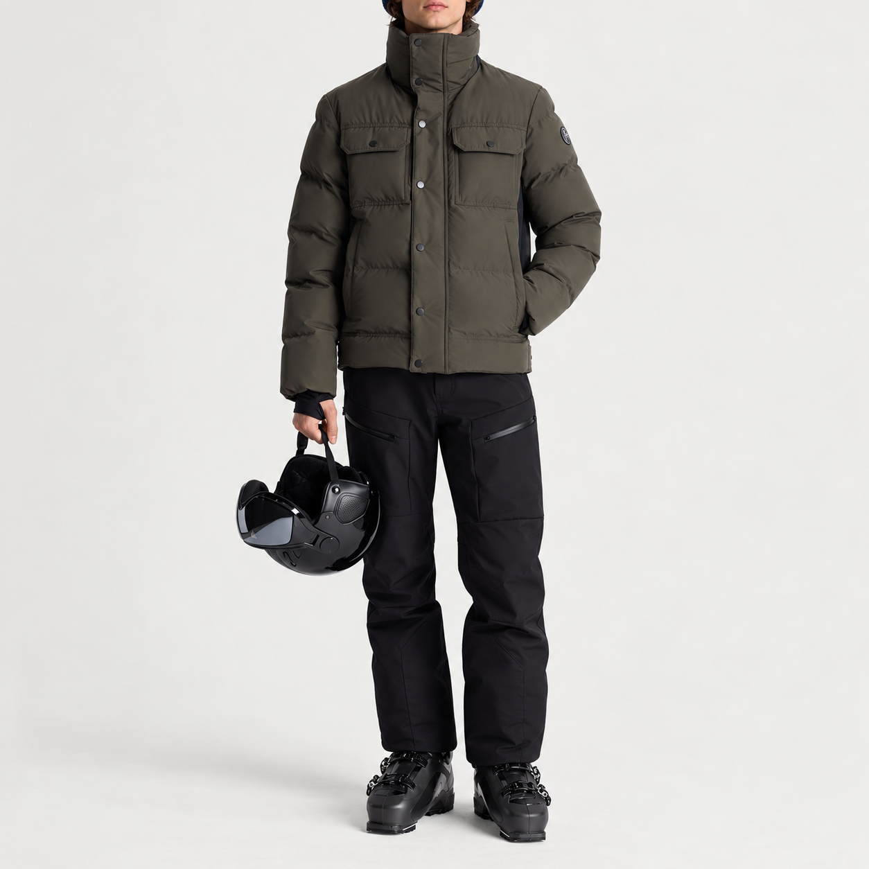 Fusalp men's Carlo Ski Jacket in Grove/Black, full outfit on model holding a ski helmet.