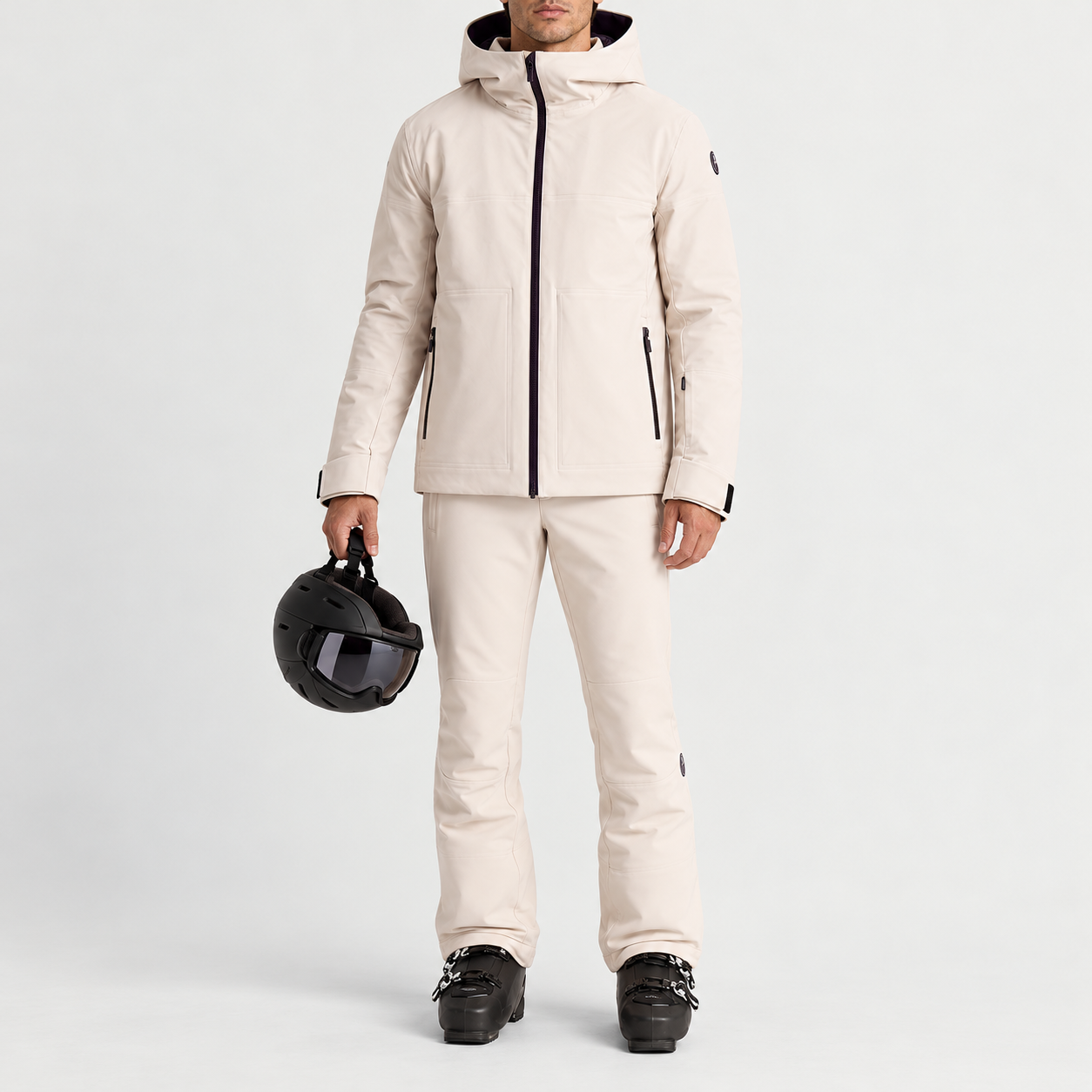 Fusalp men's Yohan Ski Jacket in Mastic, full outfit on model holding a ski helmet.