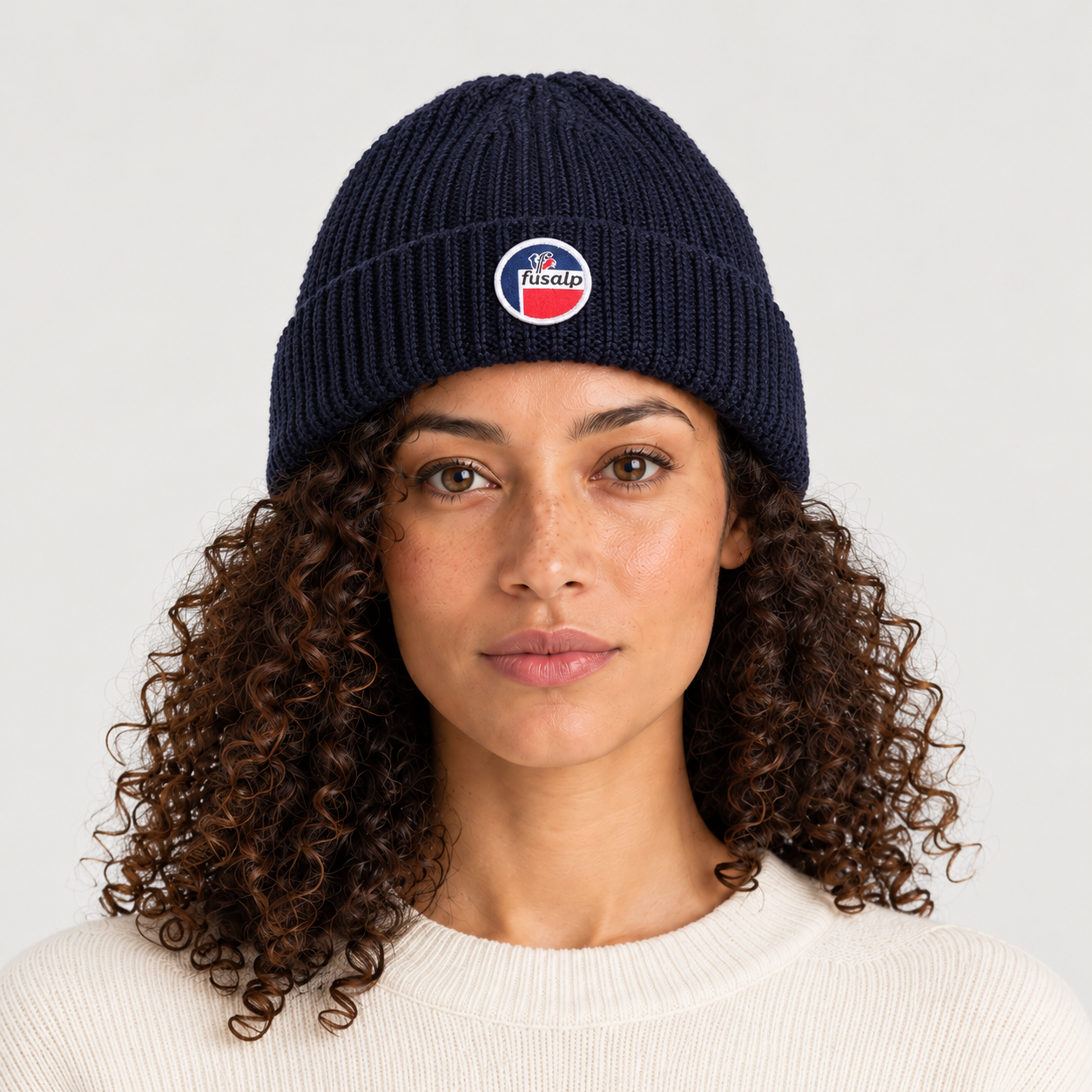 Fusalp unisex Cosmic Beanie in Navy, front view on female model.