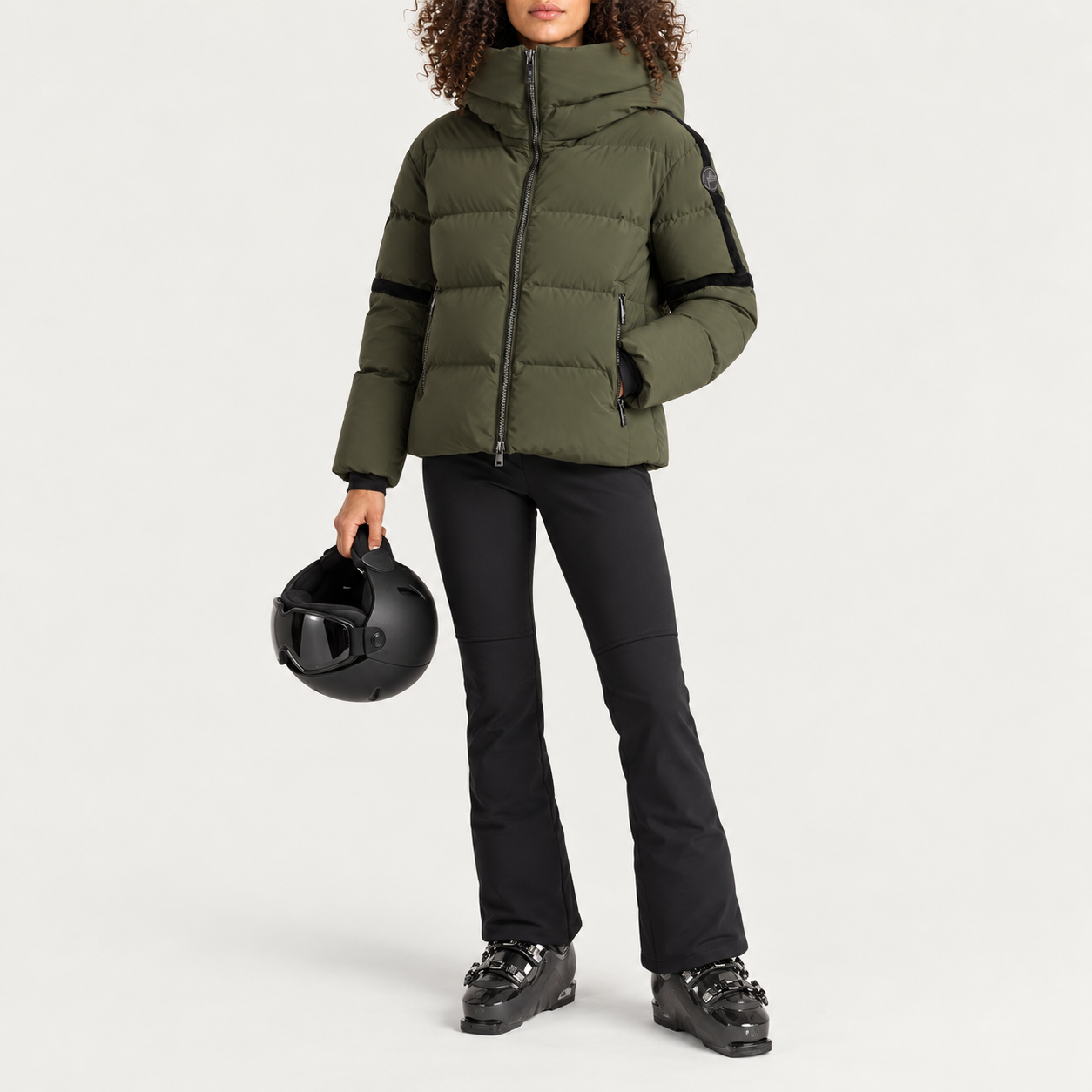 Fusalp women's Barsy II Ski Jacket in Moss Green, full outfit on model holding a ski helmet.