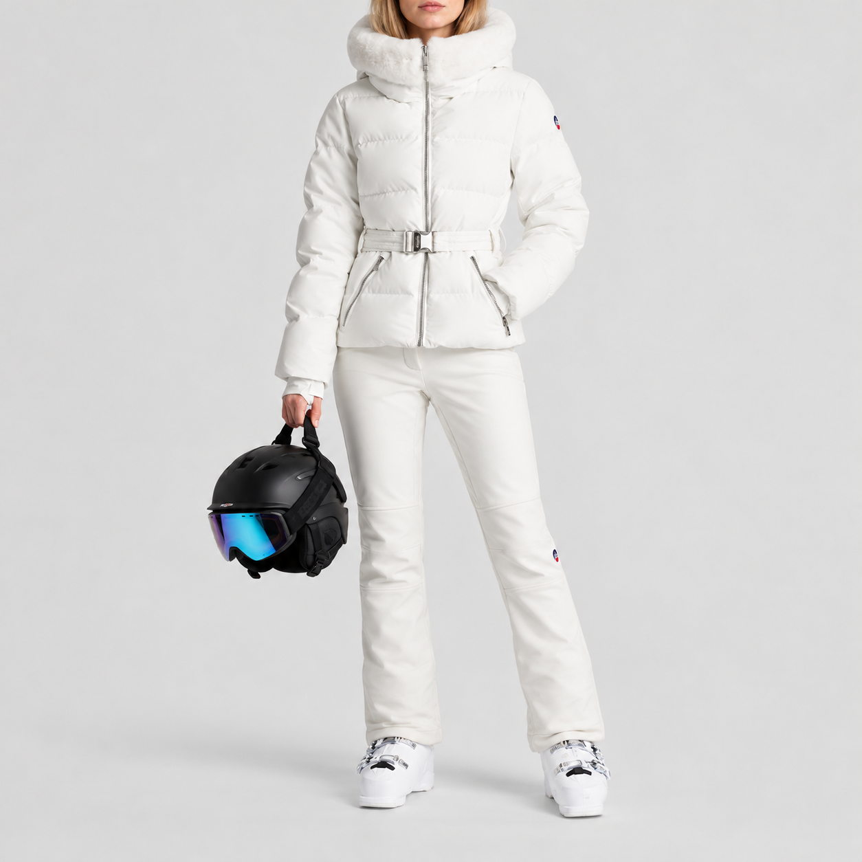Fusalp women's Delwae Ski Jacket in White, full outfit on model holding a ski helmet.
