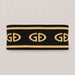 Goldbergh Tiara Headband in Black/Gold in Black Gold — front. AI-generated from manufacturer reference photographs.