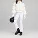 Goldbergh women's Furry Ski Jacket in White – ski pose view. AI-generated from manufacturer imagery.
