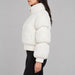 Goldbergh womens Furry Ski Jacket in White (Snow White) - model side. AI-generated from manufacturer imagery.