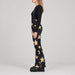 Goldbergh Sakuya Ski Pants Ski Pants in Black Gold — model side. AI-generated from manufacturer reference photographs.