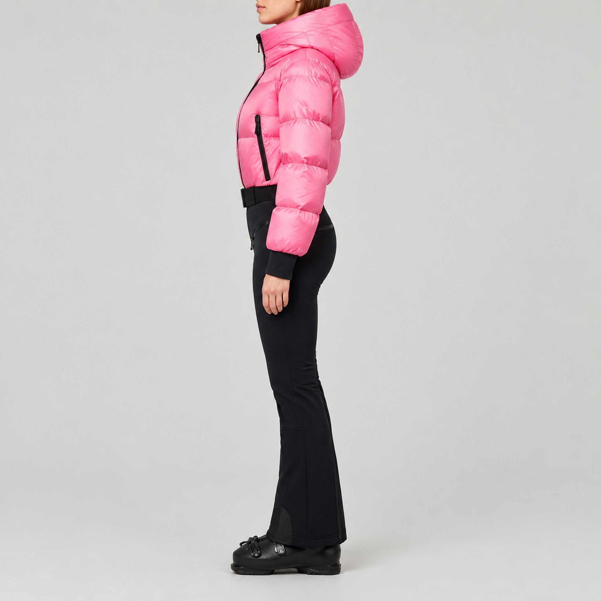 Goldbergh Sayaka Ski Suit in Pink Cosmos — model side. AI-generated from manufacturer reference photographs.