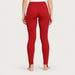 Newland womens Alpette Skinny Ski Pants in Red - model back. AI-generated from supplied artwork.