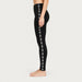 Newland womens Calith Leggings in Black - model side. AI-generated from supplied artwork.