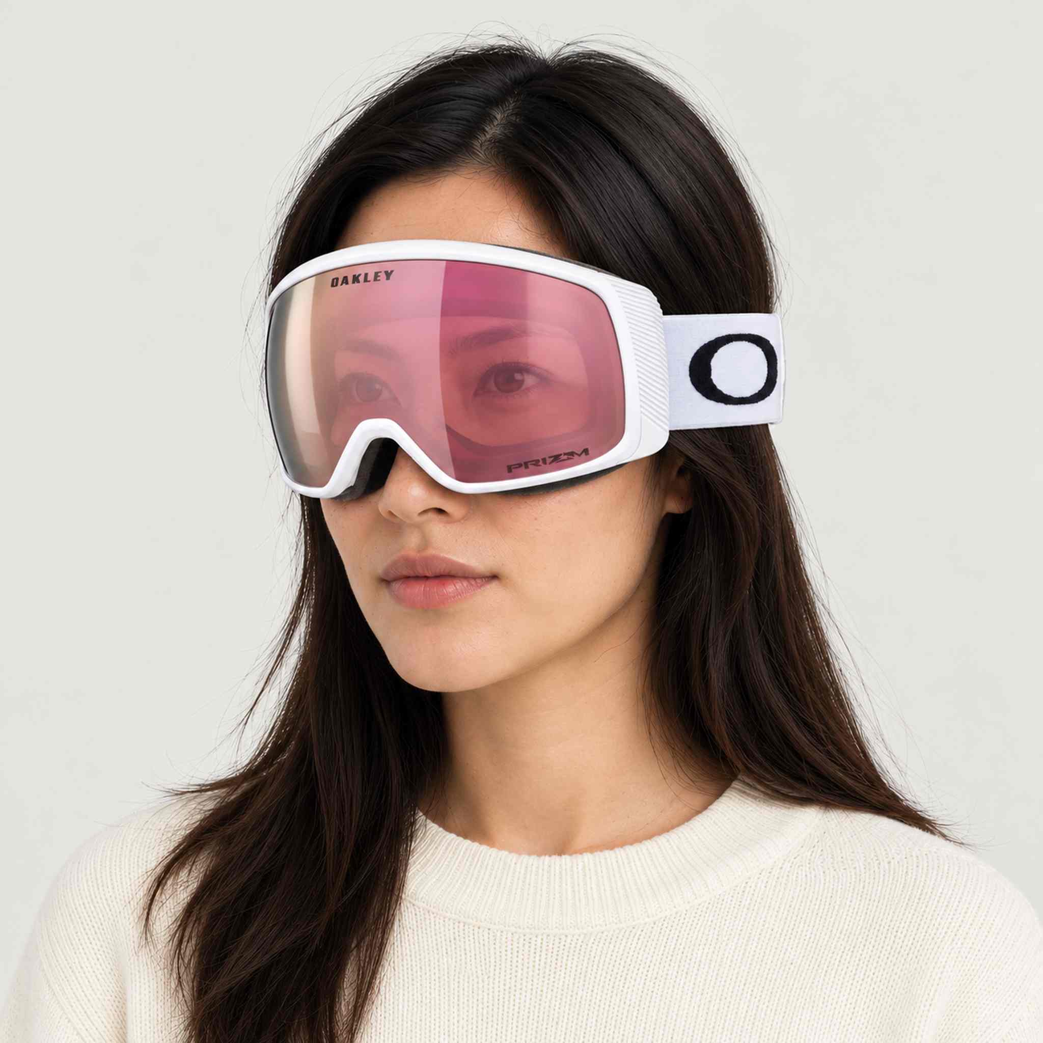 Oakley Flight Tracker M Snow Goggles in Rose Gold/White, female model.