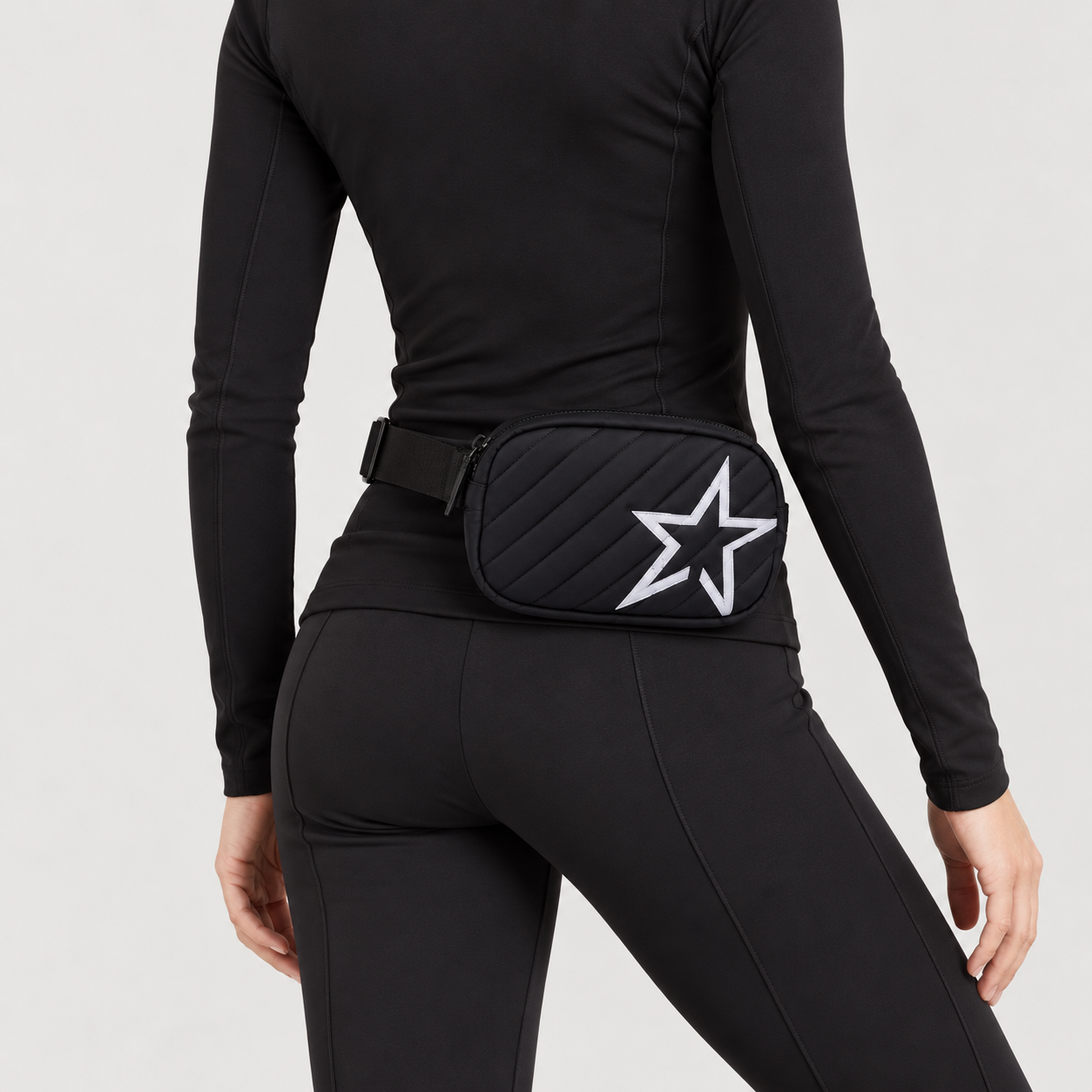 Perfect Moment unisex Star Bum Bag in Black – woman rear three quarter view