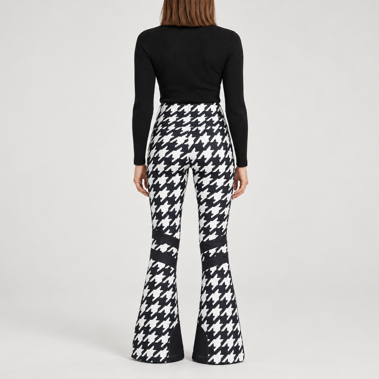 Perfect Moment women’s Aurora High Waist Flare Pant in Houndstooth Black/White – model back view