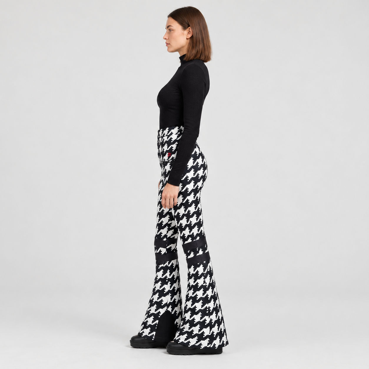 Perfect Moment women’s Aurora High Waist Flare Pant in Houndstooth Black/White – model side view