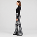 Perfect Moment women’s Aurora High Waist Flare Pant in Houndstooth Black/White – model side view